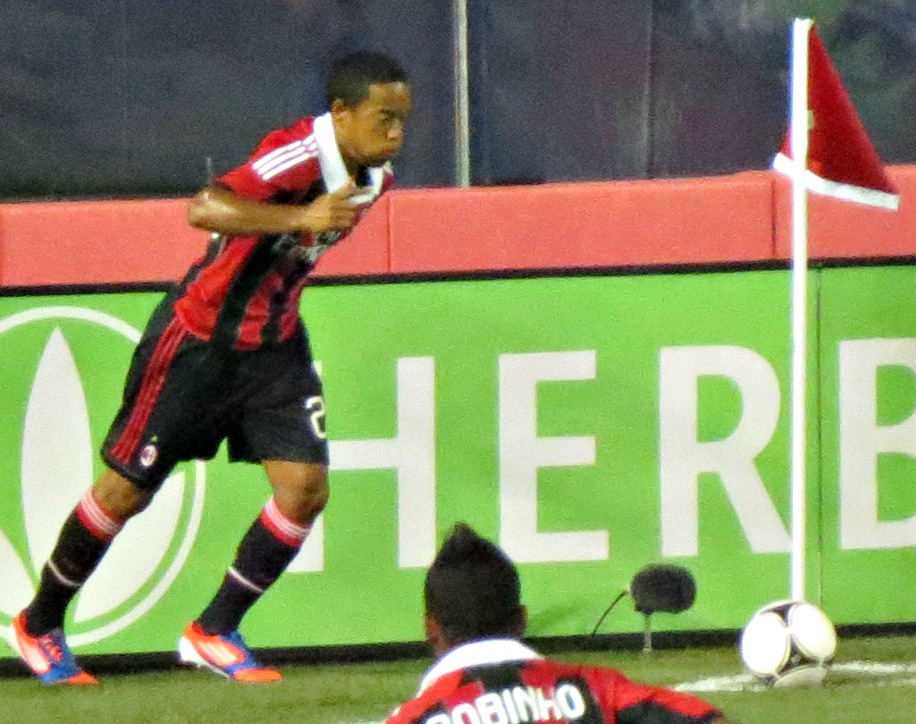 Jugador a punto de ejecutar un saque de esquina durante un partido nocturno